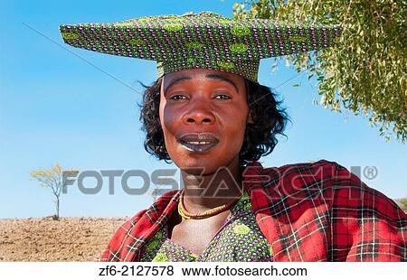 Namibia Africa Northern Desert colorful Herero tribe woman in plaid dress and hat and traditional costume in Tomakas in Puros Conservancy remote village. View Large Photo Image Stock Photo - Namibia Africa Northern Desert colorful Herero tribe woman in plaid dress and hat and traditional costume in Tomakas in Puros Conservancy remote village.. Fotosearch