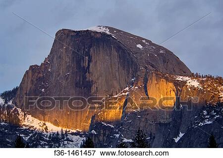 Narrow band of sunset light through spring storm clouds on the face of Half Dome, Yosemite National Park, California View Large Photo Image Stock Photo - Narrow band of sunset light through spring storm clouds on the face of Half Dome, Yosemite National Park, California. Fotosearch