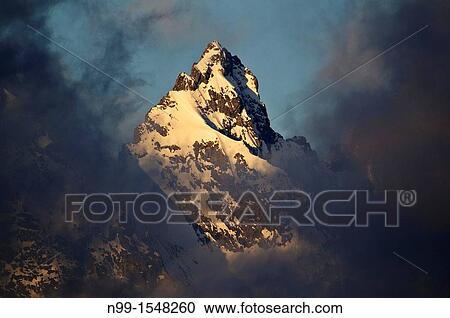 National Park Ecrins, Meije massif, peak in sunlight, between clouds, Alps, France View Large Photo Image Stock Image - National Park Ecrins, Meije massif, peak in sunlight, between clouds, Alps, France. Fotosearch