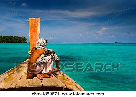 Native men in a longtail boat on Long beach Phi Phi Don island Krabi province, Andaman Sea, Thailand View Large Photo Image Stock Image - Native men in a longtail boat on Long beach Phi Phi Don island Krabi province, Andaman Sea, Thailand. Fotosearch