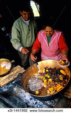 Stock Image - Natives of Ecuador cooking fritada Guaranda Ecuador. Fotosearch