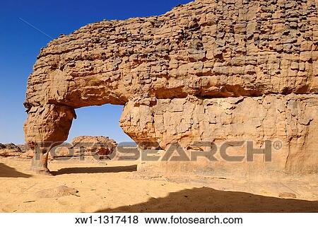 natural bridge, arch, sandstone rock formation at Youf Ahakit, Tassili du Hoggar, Wilaya Tamanrasset, Sahara Desert, Algeria, North Africa View Large Photo Image Stock Photo - natural bridge, arch, sandstone rock formation at Youf Ahakit, Tassili du Hoggar, Wilaya Tamanrasset, Sahara Desert, Algeria, North Africa. Fotosearch