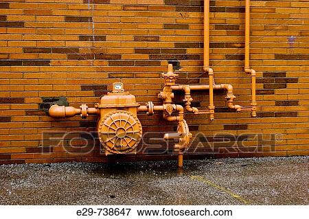 Natural gas meter with pipes running through valves and apparatus against a yellow brick wall View Large Photo Image Stock Photo - Natural gas meter with pipes running through valves and apparatus against a yellow brick wall. Fotosearch