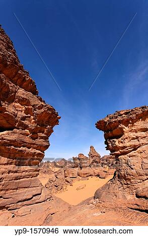 Stock Photograph - Natural rock formations in the Akakus Mountains, Sahara Desert, Libya. Fotosearch