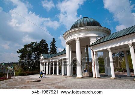 Stock Image - Neoclassical style Kolonada the colonnades (1869) at Karolinin pramen spring in Spa Gardens park Marianske Lazne aka Marienbad spa town Czech Republic Europe.. Fotosearch