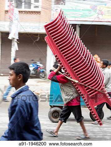 Nepal, City of Katmandu, man wearing 32 armchairs View Large Photo Image Stock Image - Nepal, City of Katmandu, man wearing 32 armchairs. Fotosearch