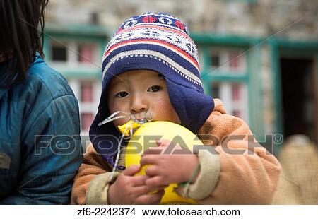 Nepal Himalayas Small child plays with balloon in the village of Monjo Solukhumbu remote Mt Everest 63. View Large Photo Image Picture - Nepal Himalayas Small child plays with balloon in the village of Monjo Solukhumbu remote Mt Everest 63.. Fotosearch