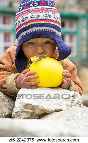 Nepal Himalayas Small child plays with balloon in the village of Monjo Solukhumbu remote Mt Everest 63. View Large Photo Image Stock Photography - Nepal Himalayas Small child plays with balloon in the village of Monjo Solukhumbu remote Mt Everest 63.. Fotosearch