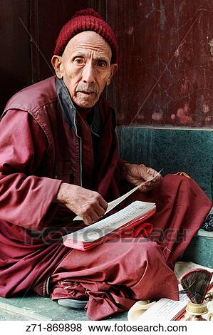 Stock Photo - Nepal, Kathmandu Valley, near Swayambhunath, tibetan pilgrim, prayer book. Fotosearch