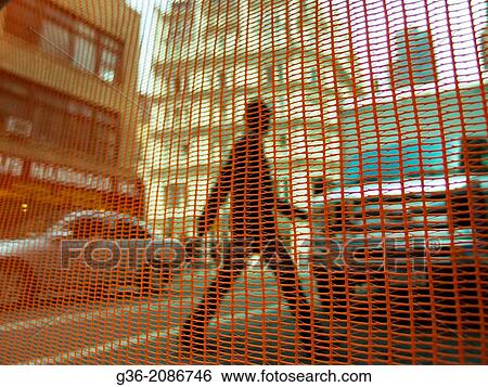 Net against man crossing the road in in New York, New York. View Large Photo Image Stock Photograph - Net against man crossing the road in in New York, New York.. Fotosearch