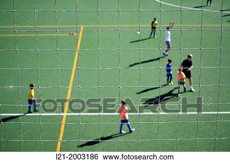 Network focused. Soccer players unfocused. Children and adults. Football field. Yellow and white lines of the football field. View Large Photo Image Stock Photograph - Network focused. Soccer players unfocused. Children and adults. Football field. Yellow and white lines of the football field.. Fotosearch
