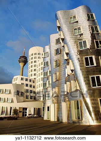 Stock Image - Neuer Zolholf buildings offices by the architect Frank Gehry, Medienhafen and Rhine TV tower Dusseldorf, Germany, Europe. Fotosearch