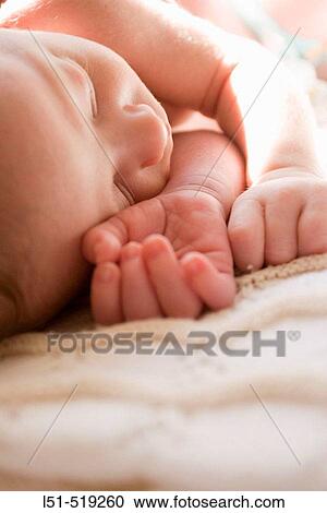 New born baby sleeping in the sun. View Large Photo Image Stock Image - New born baby sleeping in the sun.. Fotosearch