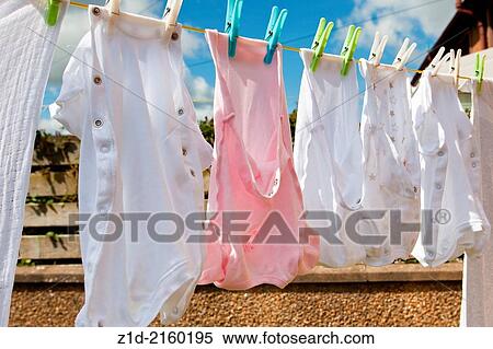 Stock Photography - new born baby's "clothes" on washing line.. Fotosearch
