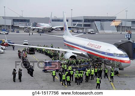 New York, New York City, NYC, Brooklyn, John F Kennedy International Airport, JFK, American Airlines, company, US carrier, aircraft, ground crew, loading casket, dead soldier, military ceremony, American flag, pay respect, honor, solemn, View Large Photo Image Stock Photograph - New York, New York City, NYC, Brooklyn, John F Kennedy International Airport, JFK, American Airlines, company, US carrier, aircraft, ground crew, loading casket, dead soldier, military ceremony, American flag, pay respect, honor, solemn,. Fotosearch