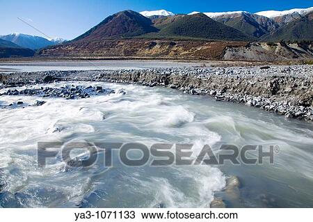 Stock Image - New Zealand, Canterbury, Arthur's Pass National Park Creek running into the Poulter River and the Poulter Valley. Fotosearch