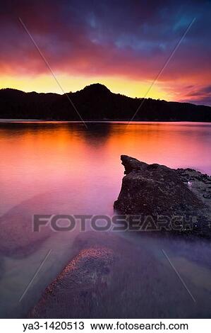 Stock Image - New Zealand, Nelson, Abel Tasman National Park Sunset on the coastline by Anchorage Hut, on the coast great walk. Fotosearch