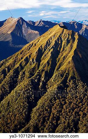 New Zealand, Southland, Fiordland National Park The impressive mountain peaks of Fiordland viewed from near the Hanging Valley shelter on the Kepler Great Walk track View Large Photo Image Picture - New Zealand, Southland, Fiordland National Park The impressive mountain peaks of Fiordland viewed from near the Hanging Valley shelter on the Kepler Great Walk track. Fotosearch