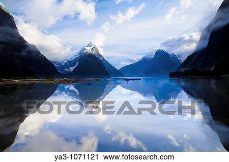 New Zealand, Southland, Fiordland National Park A clearing storm above Mitre peak, reflected in the still waters of the Milford Sound View Large Photo Image Stock Image - New Zealand, Southland, Fiordland National Park A clearing storm above Mitre peak, reflected in the still waters of the Milford Sound. Fotosearch