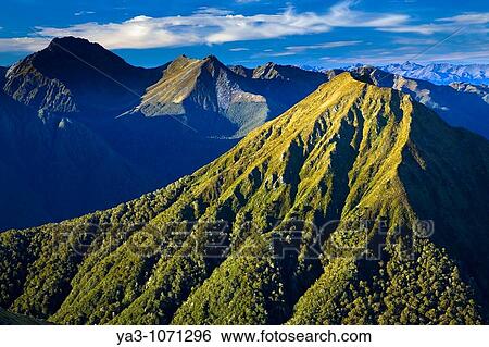 Stock Photograph - New Zealand, Southland, Fiordland National Park The impressive mountain peaks of Fiordland viewed from near the Hanging Valley shelter on the Kepler Great Walk track. Fotosearch