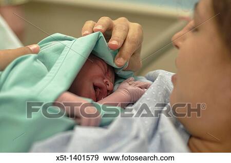 Stock Photo - Newborn baby and mother in ther maternity ward. Fotosearch
