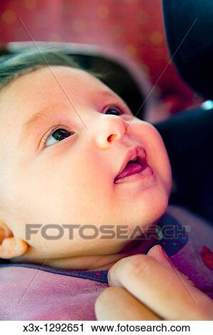 Newborn baby girl looking in wonder View Large Photo Image Stock Image - Newborn baby girl looking in wonder. Fotosearch