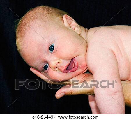 Stock Photo - newborn in hand. Fotosearch