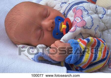 Newborn sleeping with pacifier View Large Photo Image Stock Photo - Newborn sleeping with pacifier. Fotosearch