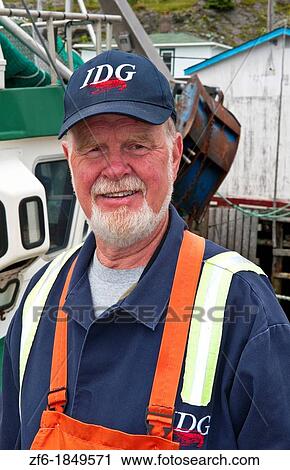 Stock Image - Newfoundland Canada Port de Graves harbor working Port Quality Inspector for fish. Fotosearch