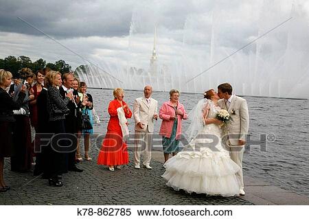 Newly married couple celebrates at Vasilevskiy island by the Neva river St Petersburg, Russia View Large Photo Image Stock Photography - Newly married couple celebrates at Vasilevskiy island by the Neva river St Petersburg, Russia. Fotosearch