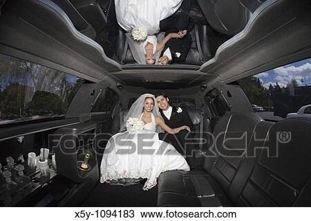 Newly married couple in side of limousine View Large Photo Image Stock Image - Newly married couple in side of limousine. Fotosearch