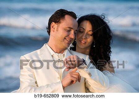 Stock Photo - Newly married couple on the beach.. Fotosearch