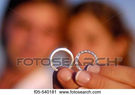 Newly young married couple showing their wedding rings. View Large Photo Image Stock Image - Newly young married couple showing their wedding rings.. Fotosearch