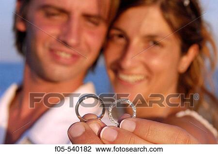 Newly young married couple showing their wedding rings. View Large Photo Image Stock Image - Newly young married couple showing their wedding rings.. Fotosearch
