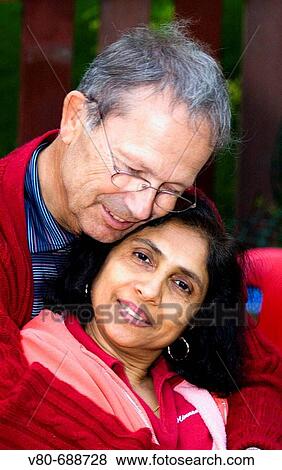 Stock Photo - Newlyweds age 60 East Indian and Caucasian enjoying a romantic moment St Paul Minnesota USA. Fotosearch