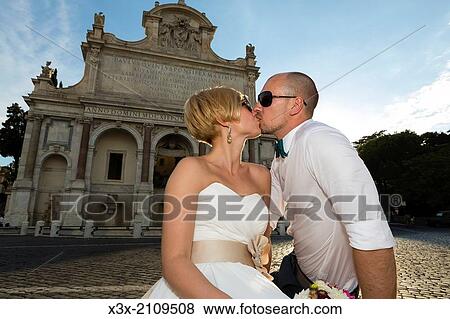 Stock Photo - Newlyweds at the Gianicolo water fountain in Rome, Italy.. Fotosearch