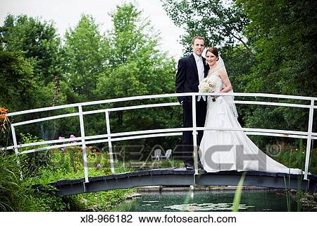 Newlyweds, Bride and Groom on bridge View Large Photo Image Stock Image - Newlyweds, Bride and Groom on bridge. Fotosearch