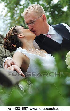 Newlyweds couple kissing on a public bench, France View Large Photo Image Stock Photo - Newlyweds couple kissing on a public bench, France. Fotosearch
