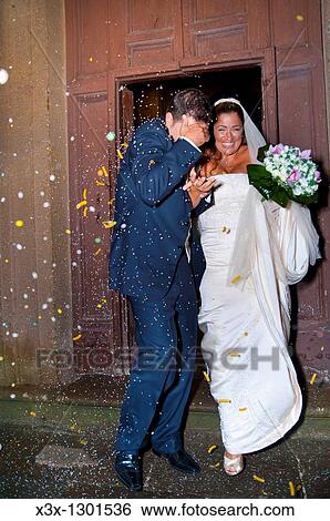 Newlyweds during rice and pasta throwing after wedding ceremony View Large Photo Image Stock Photograph - Newlyweds during rice and pasta throwing after wedding ceremony. Fotosearch