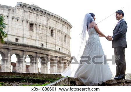 Newlyweds in front of the roman Colosseum in Rome Italy View Large Photo Image Stock Image - Newlyweds in front of the roman Colosseum in Rome Italy. Fotosearch