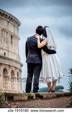 Newlyweds in front of the roman Colosseum in Rome Italy View Large Photo Image Stock Image - Newlyweds in front of the roman Colosseum in Rome Italy. Fotosearch