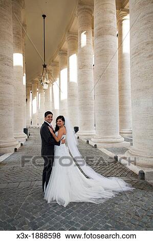 Stock Photo - Newlyweds in the colonnade Saint Peter's cathedral Vatican Rome Italy. Fotosearch