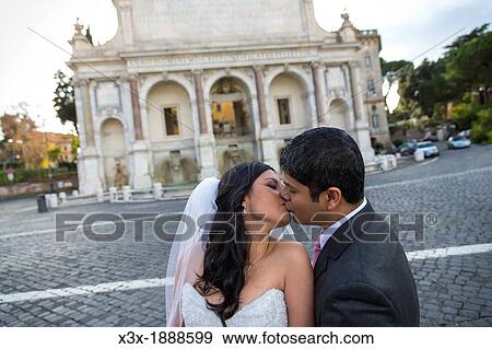Newlyweds kissing in front of Fontanone del Gianicolo in Rome Italy View Large Photo Image Stock Photo - Newlyweds kissing in front of Fontanone del Gianicolo in Rome Italy. Fotosearch