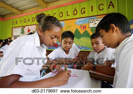 Stock Photo - Nicaragua. CANTERA projects. Fray Jesus de Pamplona primary school at Los Planes de Cuajachillo. Ecology Brigade which teaches children to care for the environment. Children working among themselves.. Fotosearch