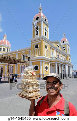 Nicaragua, Granada, Avenida Guzman, Cathedral de Granada, Central Plaza, colonial heritage, historic district, cathedral, tower, food, vendor, cashew halves, nuts, plastic bags, Hispanic, man, middle age, moustache, smiling, View Large Photo Image Stock Photography - Nicaragua, Granada, Avenida Guzman, Cathedral de Granada, Central Plaza, colonial heritage, historic district, cathedral, tower, food, vendor, cashew halves, nuts, plastic bags, Hispanic, man, middle age, moustache, smiling,. Fotosearch