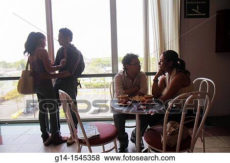 Nicaragua, Managua, Avenida Simon Bolivar, Plaza Inter, shopping mall, food court, coffee shop, window, table, chair, Hispanic, man, woman, couple, romantic, private moment, young adult, relationship, touching, View Large Photo Image Stock Photo - Nicaragua, Managua, Avenida Simon Bolivar, Plaza Inter, shopping mall, food court, coffee shop, window, table, chair, Hispanic, man, woman, couple, romantic, private moment, young adult, relationship, touching,. Fotosearch