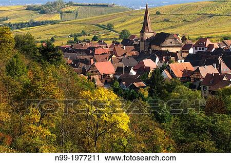 Niedermorschwihr, twisted clock tower, village in the vineyards, colours of autumn, Alsace, France. View Large Photo Image Stock Image - Niedermorschwihr, twisted clock tower, village in the vineyards, colours of autumn, Alsace, France.. Fotosearch
