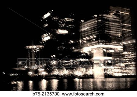 Night blured view of office buildings with reflections in the water in The Docks, Canary Wharf, London, England, UK, Europe. View Large Photo Image Stock Image - Night blured view of office buildings with reflections in the water in The Docks, Canary Wharf, London, England, UK, Europe.. Fotosearch