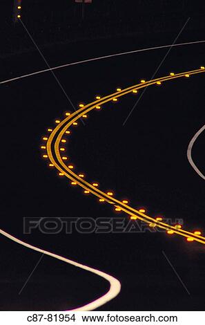 Night, Curve in road, yellow centerline and reflectors, white edge markings View Large Photo Image Picture - Night, Curve in road, yellow centerline and reflectors, white edge markings. Fotosearch