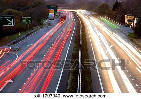 Stock Image - night falling over the A34 with light trails. Fotosearch